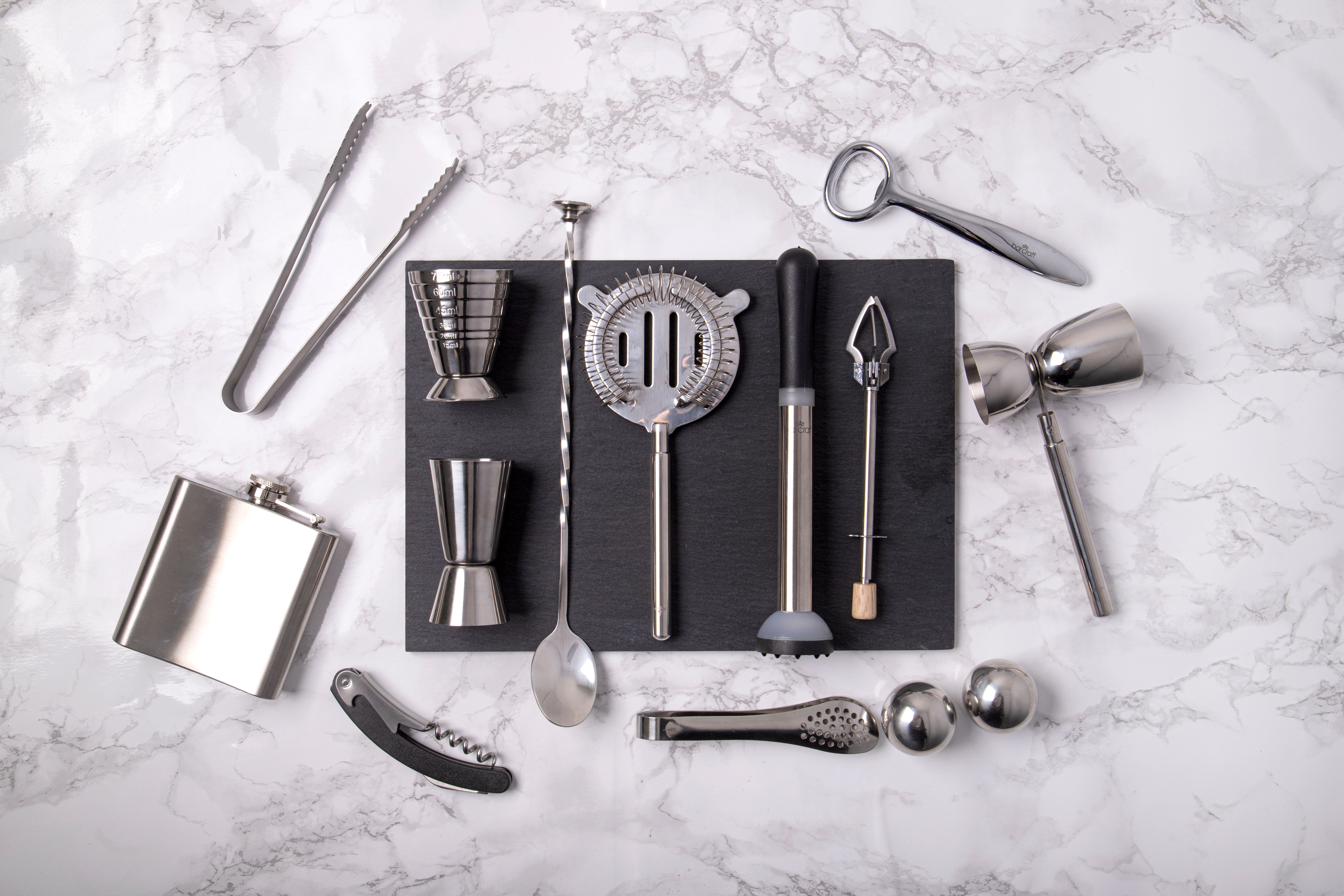 Bar tools laid out on a marble counter
